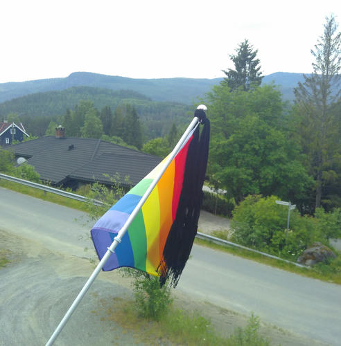 Rainbow flag with a black scarf