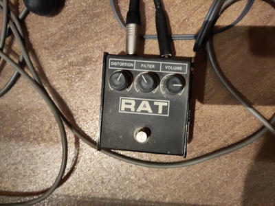 Closeup of a RAT distortion pedal with the dials set to grim crunchy bass